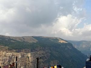a view of a mountain with clotheslines in front of it at Hams Cherrapunji in Cherrapunji
