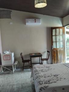 a bedroom with a bed and a table and chairs at Falésias de Carapibus in Jacumã
