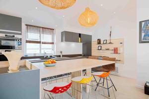 a kitchen with a large wooden table and chairs at Granville centre - Duplex 6 pers in Granville +13 photos