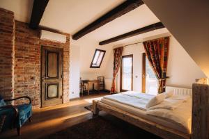 a bedroom with a bed and a brick wall at Vintage Home Vendégház in Miskolctapolca