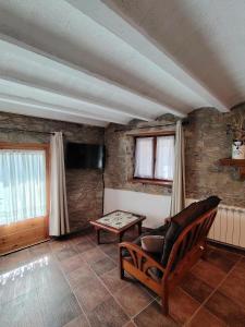 a living room with a couch and a table at Cal Tonico Rural in Ribes de Freser
