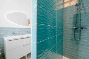 a bathroom with a shower and a sink at Les coques bleues in Granville +20 photos