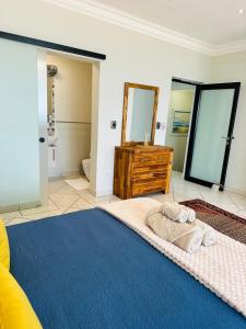 a bedroom with a large bed with towels on it at SeafrontC in Swakopmund +42 photos