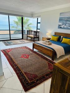 a bedroom with a bed and a view of the ocean at SeafrontC in Swakopmund