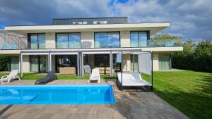 a house with a swimming pool in front of it at Luxury Apartments in Balatonalmádi I Almádi Lux Apartman IV - Velvet Oak in Balatonalmádi