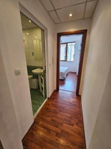 a hallway with a door leading to a bedroom at Апартамент Перла in Sandanski +26 photos