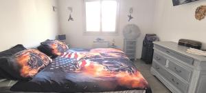a bedroom with a bed with an american flag blanket at Charming house Aix Marseille with outdoor area in Bouc-Bel-Air