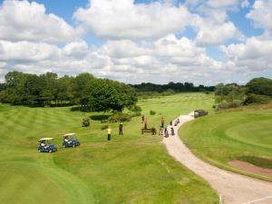 a group of people standing on a golf course at North Shore Hotel in Skegness