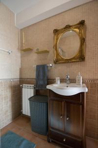 a bathroom with a sink and a mirror at Casa dos Grous in Ponte de Lima