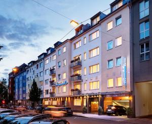 a large building with cars parked in front of it at Hotel Imperial Dusseldorf - Sure Collection by BW in Düsseldorf