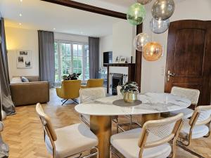 a living room with a table and chairs at Stadtvilla Heimatliebe direkt am Park und citynah gelegen für bis zu 5 Personen, Haustiere willkommen in Nordhorn