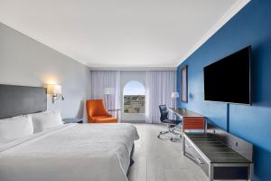 a hotel room with a bed and a desk and a tv at Fiesta Inn Express Nuevo Laredo in Nuevo Laredo