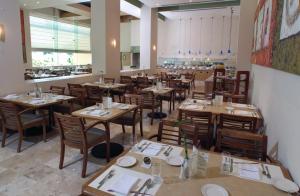 a dining room with tables and chairs in a restaurant at Fiesta Inn Culiacan in Culiacán