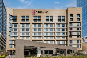 a large building with a fish inn sign on it at Fiesta Inn Monterrey Valle in Monterrey +24 photos