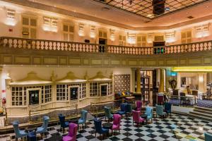 a lobby of a hotel with chairs and tables at Gamma Monterrey Gran Hotel Ancira in Monterrey