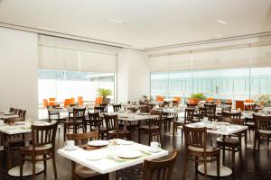 an empty dining room with tables and chairs at Fiesta Inn Monterrey Tecnologico in Monterrey