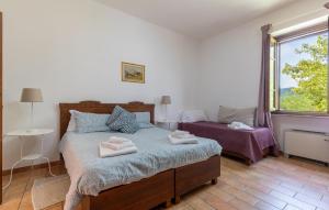a bedroom with a bed with towels on it at 1 Bedroom Awesome Apartment In Montone in Montone
