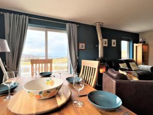 a dining room table with a bowl on top of it at Hirta Cottage in Staffin +22 photos