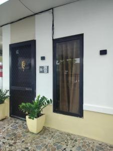 una stanza con una porta nera e una pianta di Bali Residences a Agus