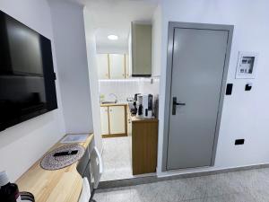 a kitchen with a table and a door leading to a kitchen at Spartan Nest Modern Cozy Stay in Sparta