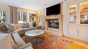 a living room with a couch and a fireplace at Linksview Chalet North in Vail