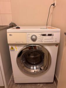 a washer and dryer in a room at Minimalist 2-Bed, 2-Bath Apartment in Melbourne CBD - Free Parking in Melbourne