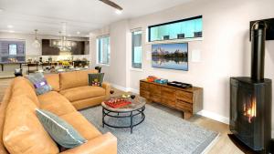 a living room with a couch and a fireplace at Metropolitan House in Steamboat Springs