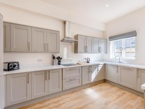 a kitchen with white cabinets and a window at No 2 - Chepstow - Uk47937 in Oswestry