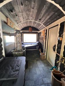a room with a bed and a fireplace in a train at Nanay Bay Glamping in Bogustan