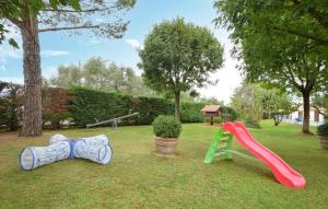 a playground with a slide and a slideintend at Cozy Apartment In Castiglione Del Lago in Castiglione del Lago