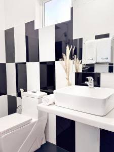 a bathroom with a white sink and a toilet at Santino Boutique in Mirissa