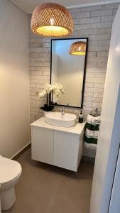 a bathroom with a sink and a mirror and a toilet at Kalliste Boutique Stays - Hermanus in Hermanus +17 photos