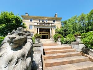 a statue of a lion in front of a building at Historic Cotton Mansion by Heirloom Boutique Collection in Duluth