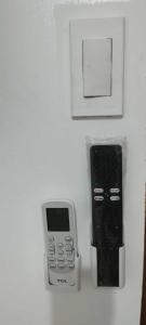 a cell phone and an ipod sitting on a counter at Felipas City Center Budget Room Home Stay in San Fernando +12 photos