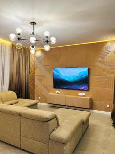 a living room with a flat screen tv on a wall at Квартира 17-23 in Aktau