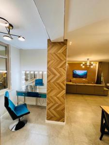 a living room with a blue chair and a couch at Квартира 17-23 in Aktau