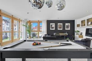a ping pong table in a living room with at Penthouse Noir - Wyndale Living - Central BHam 2BR in Birmingham