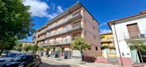 an apartment building with cars parked in front of it at Di Cicco Living in San Giorgio a Liri