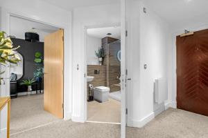 a bathroom with a sink and a toilet in a room at Penthouse Noir - Wyndale Living - Central BHam 2BR in Birmingham +52 photos