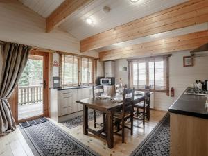 a kitchen with a table and chairs in a room at Jessica in Edrom