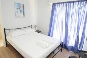 sypialnia z łóżkiem z niebieską zasłoną w obiekcie Lovely Studio With Amazing Terrace w Atenach