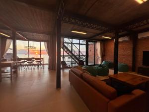 a living room with a couch and a table at Sairee Beach Penthouse in Ko Tao