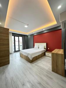 a bedroom with a bed and a red wall at Bazalt Apart Hotel in Trabzon +88 photos