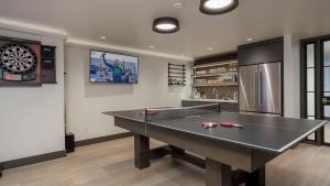 a ping pong table in a room with a dartboard at Orion Lodge in Steamboat Springs