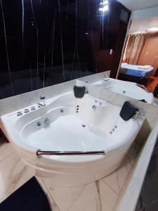 a bathroom with a white tub and a sink at Hostal Break in Arequipa