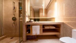 a bathroom with a sink and a toilet and a shower at HeeFun Apartment GZ -Poly World Trading Center-walking distance to Canton Fair in Guangzhou +37 photos