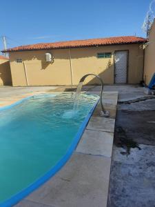 a pool with a water hose in a yard at Casa Brisas in Luis Correia +10 photos