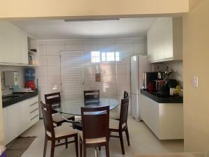 a kitchen with a table and chairs in a kitchen at Casa Brisas in Luis Correia