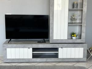 a television on a entertainment center in a living room at Casa BELLOCCHIO in Perugia