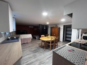 a kitchen and living room with a table in a kitchen at Bellevue in Montpezat-de-Quercy